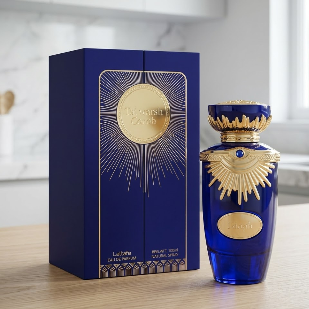 Frasco de perfume Lattafa Emaan en color azul y dorado con diseño labrado elegante.
